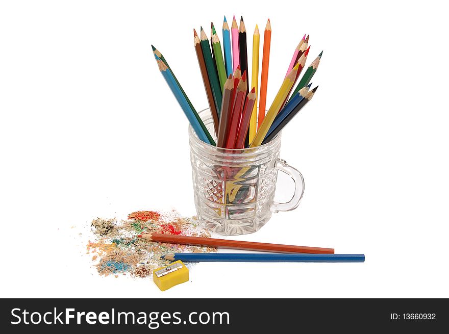 Colour pencils in a glass glass and a sharpener