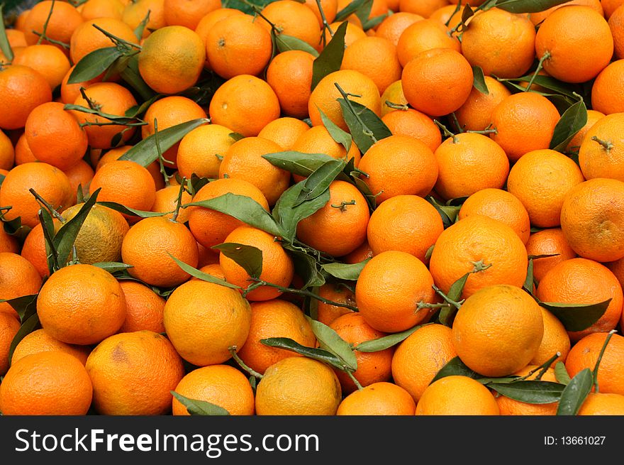 Pile of sweet orange citrus with leaves. Pile of sweet orange citrus with leaves