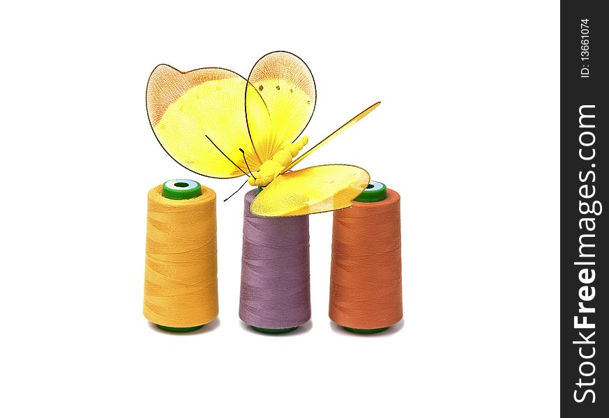 Coloreds spools with butterfly isolated on white background