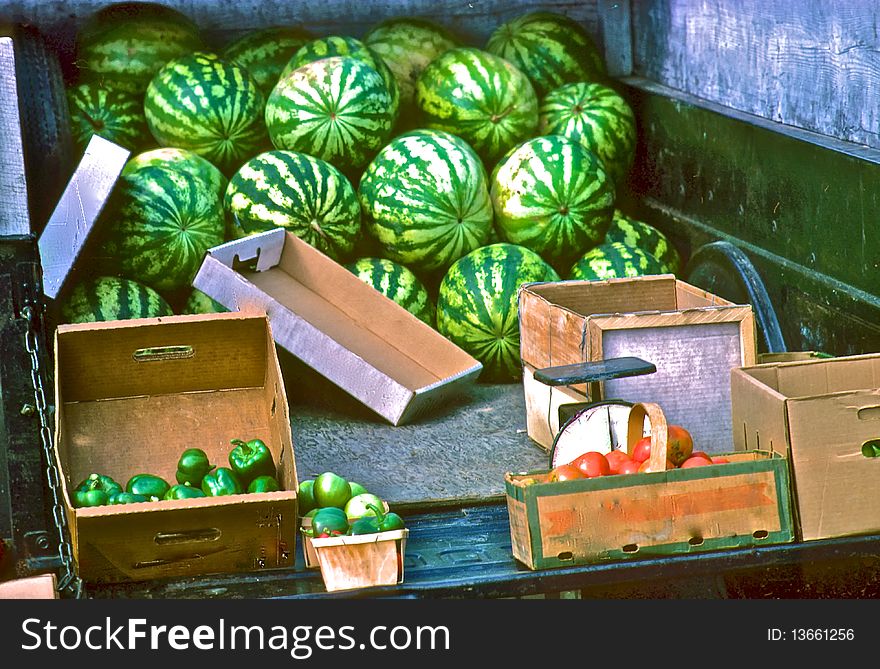 Watermelons and peppers in back of pickup truck at city market. Watermelons and peppers in back of pickup truck at city market