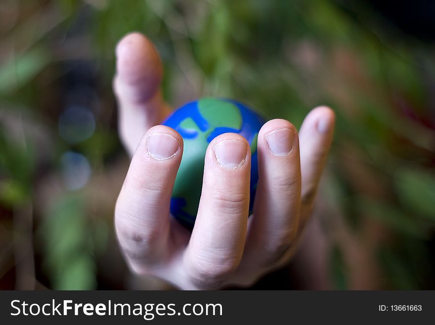 Ecological vision where human hand squeeze our planet. Ecological vision where human hand squeeze our planet