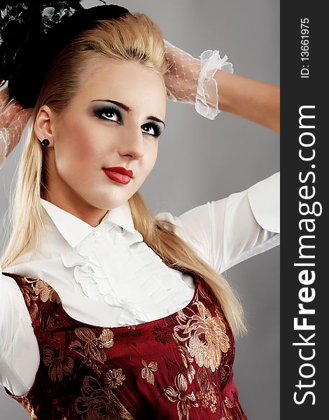 Portrait of the elegant young woman in 19th century costume. Shot in a studio. Portrait of the elegant young woman in 19th century costume. Shot in a studio.