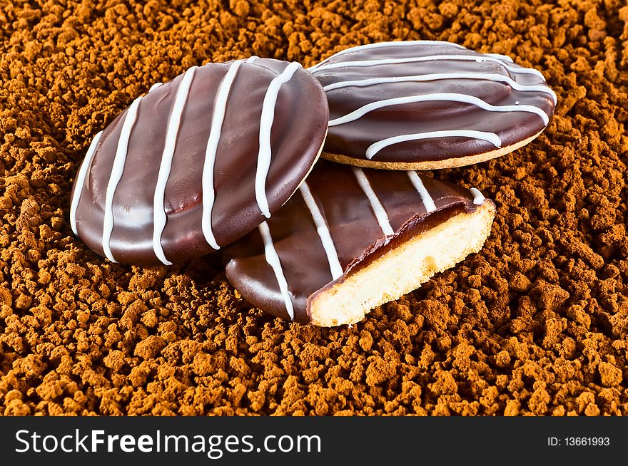 Cookies in chocolate against coffee granules
