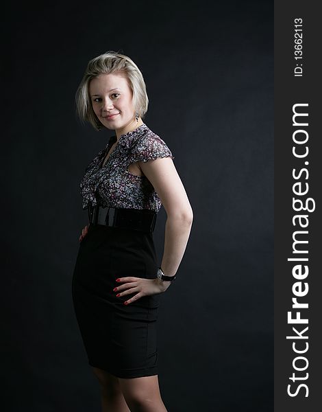 Portrait of the beautiful, young girl-blonde in a black-and-white dress. Portrait of the beautiful, young girl-blonde in a black-and-white dress