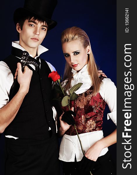 Portrait of the elegant young couple in medieval era costumes. Shot in a studio. Portrait of the elegant young couple in medieval era costumes. Shot in a studio.