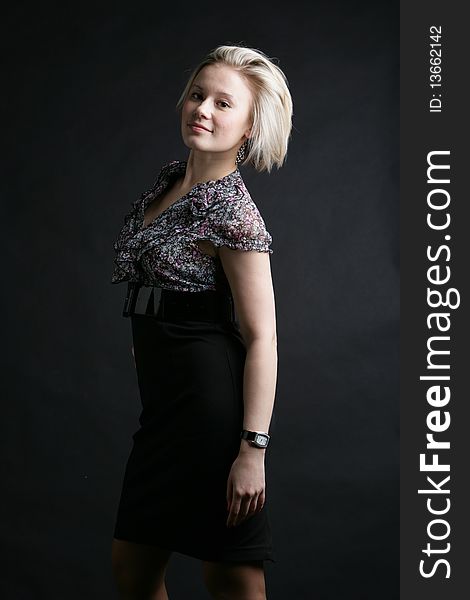 Portrait of the beautiful, young girl-blonde in a black-and-white dress. Portrait of the beautiful, young girl-blonde in a black-and-white dress