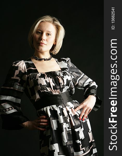 Portrait of the beautiful, young girl-blonde in a black-and-white dress. Portrait of the beautiful, young girl-blonde in a black-and-white dress