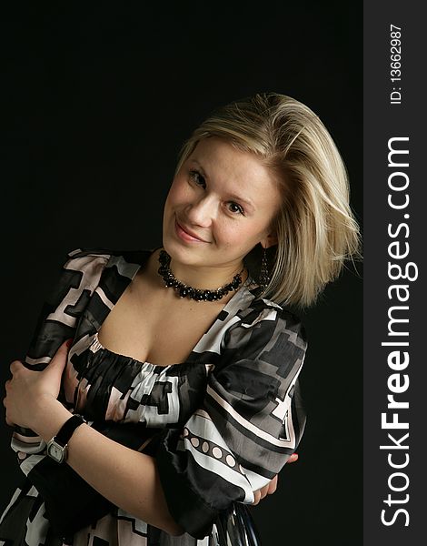 Portrait of the beautiful, young girl-blonde in a black-and-white dress. Portrait of the beautiful, young girl-blonde in a black-and-white dress