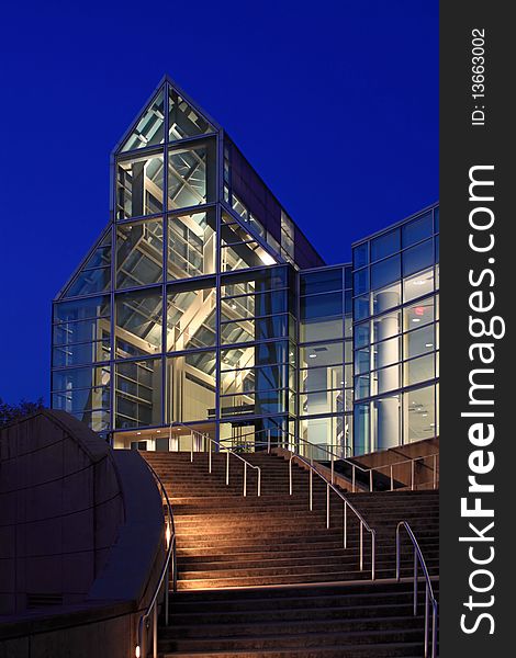 A night shot of a modern glass, and steel building. A night shot of a modern glass, and steel building.