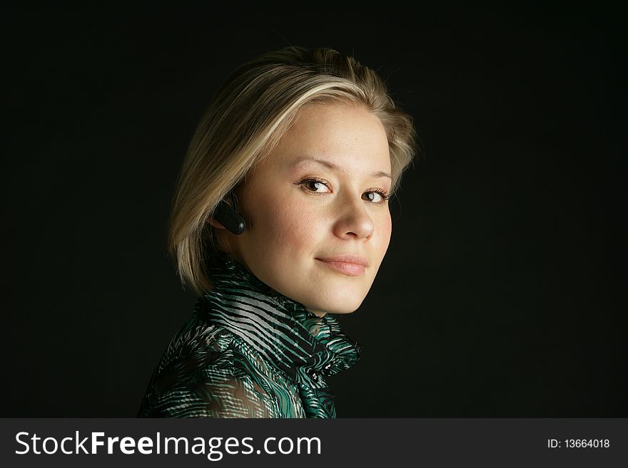 Portrait of the beautiful, young girl-blonde in a green transparent blouse. Portrait of the beautiful, young girl-blonde in a green transparent blouse