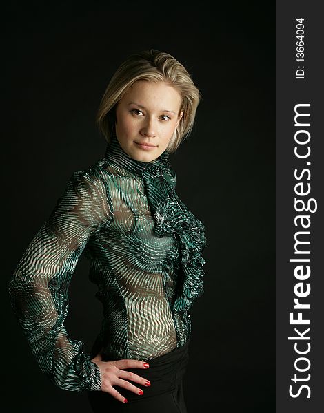 Portrait of the beautiful, young girl-blonde in a green transparent blouse. Portrait of the beautiful, young girl-blonde in a green transparent blouse