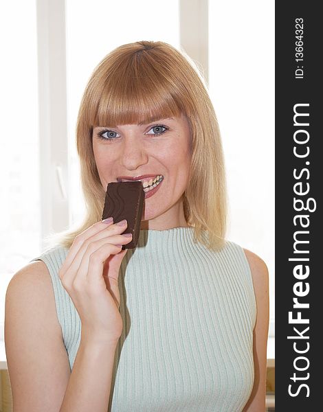 The young woman eats a piece of a chocolate pie
