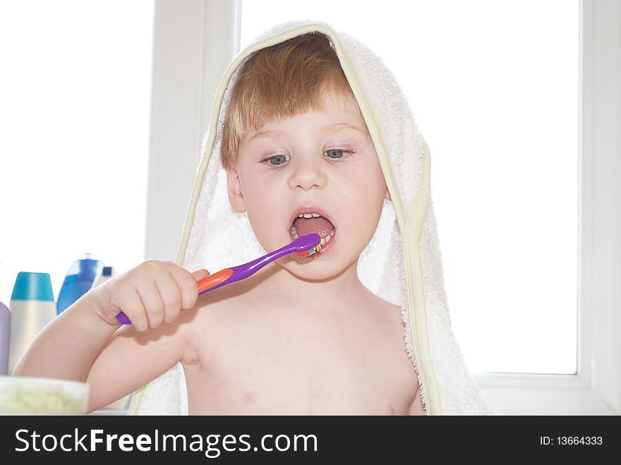 The little boy cleans a teeth on background. The little boy cleans a teeth on background
