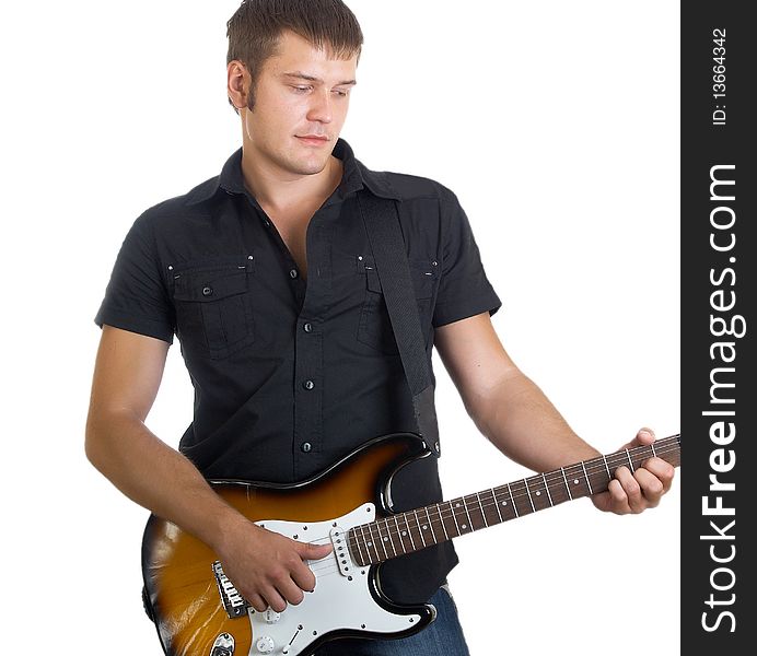 The serious beautiful guy with a guitar in a dark shirt with a guitar in hands. The serious beautiful guy with a guitar in a dark shirt with a guitar in hands