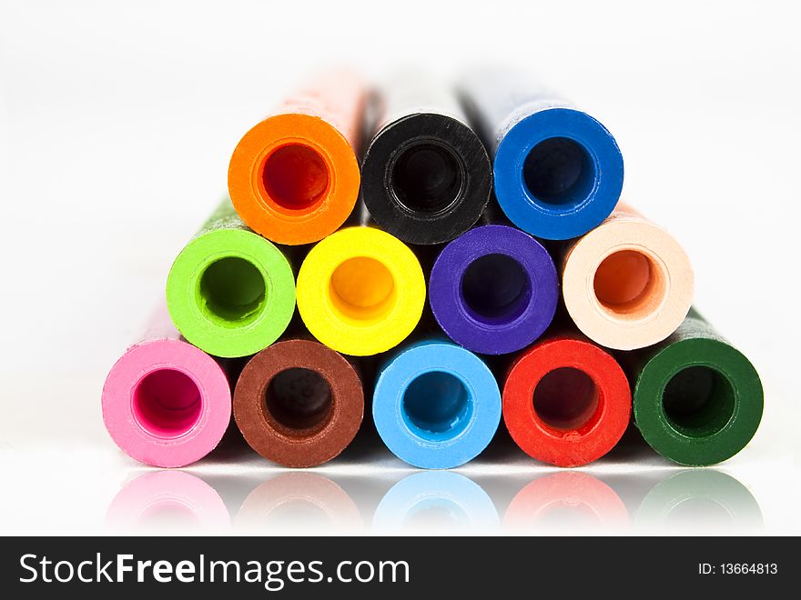 Colored crayons  on white background with reflection. Colored crayons  on white background with reflection