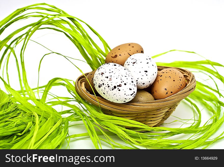Easter eggs, basket and grass. Easter eggs, basket and grass