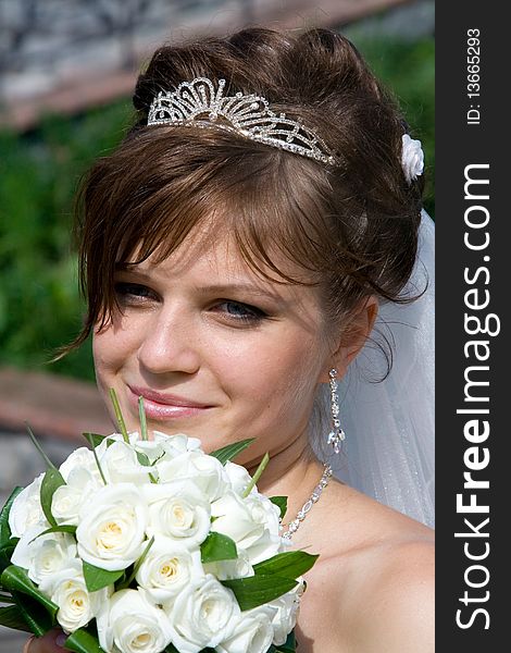 Young beautiful bride with wedding bouquet