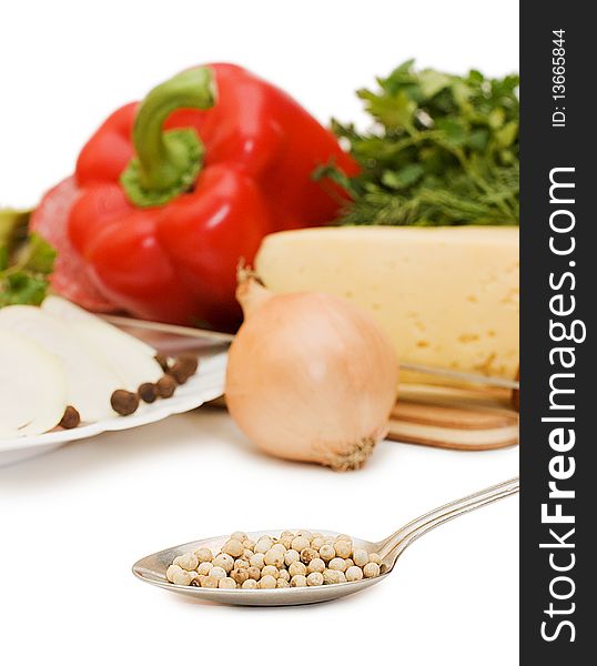 Spices on a spoon against vegetables