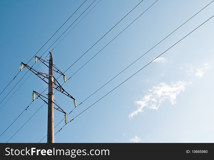 High voltage power supply line on a blue sky background. High voltage power supply line on a blue sky background