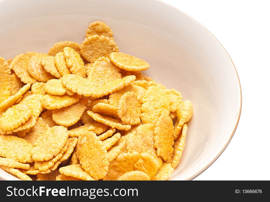 Corn-flakes on white plate. white isolated background.