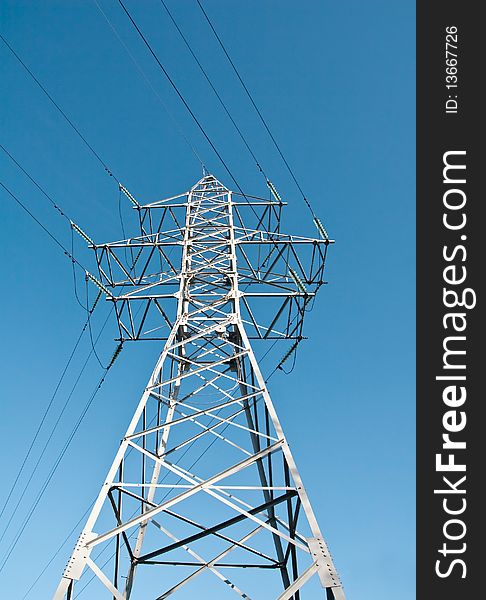 High voltage power supply line on a blue sky background. High voltage power supply line on a blue sky background