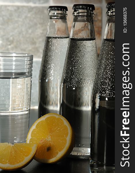 Bottle with mineral water and a lemon