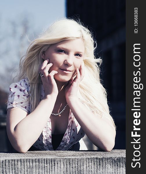 Portrait of blond girl with long hair outside