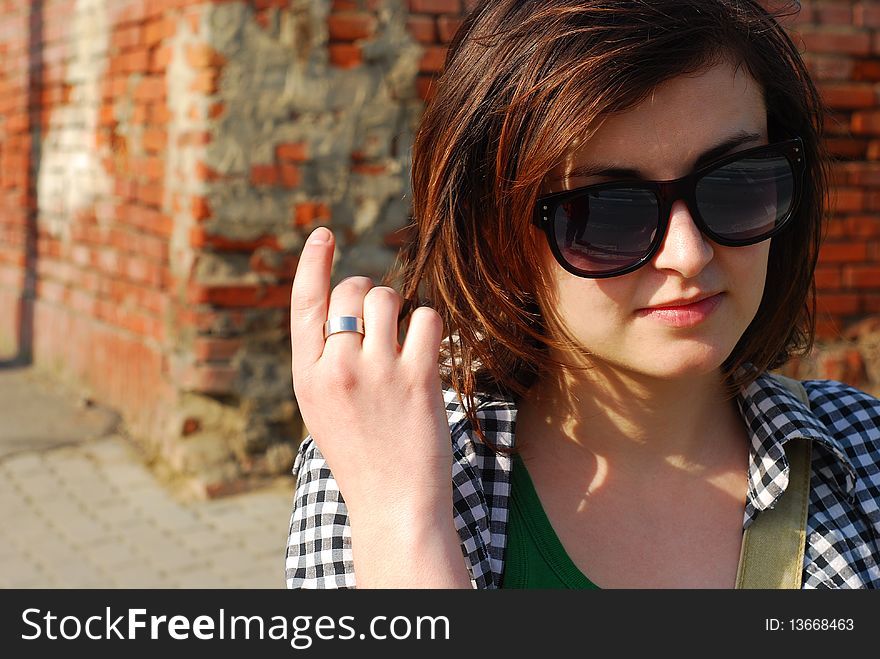 Portrait of a young trendy woman wearing sunglasses. Portrait of a young trendy woman wearing sunglasses