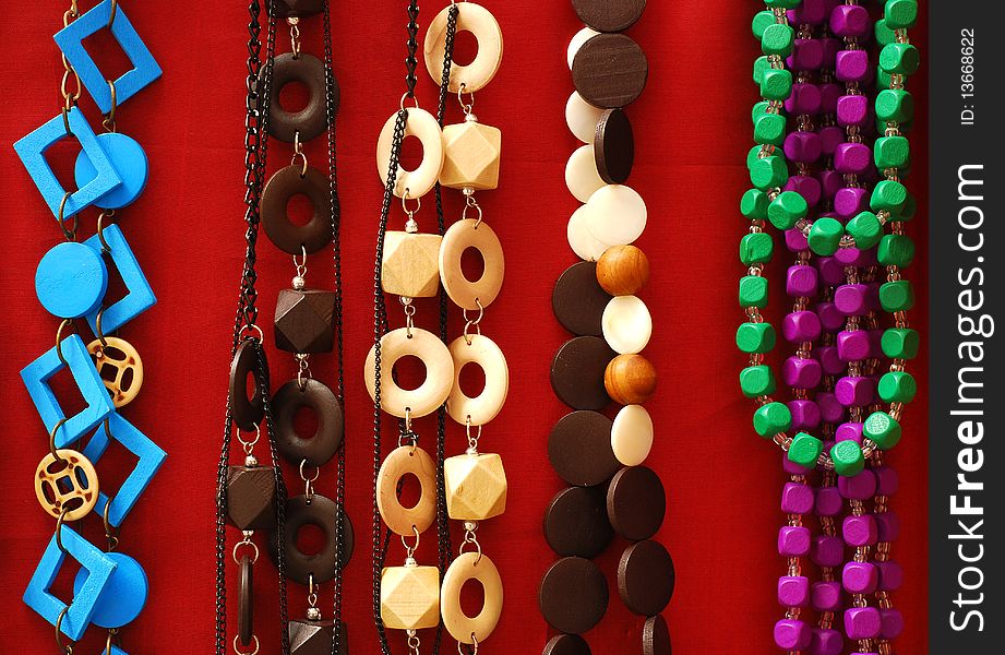 Colored necklaces over red background