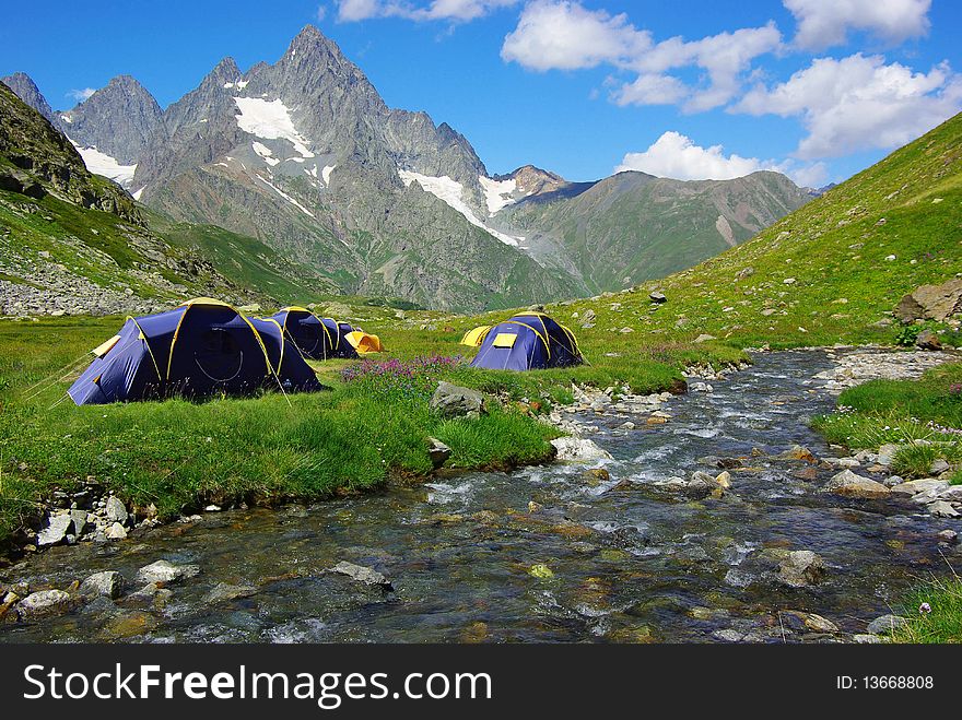 On the photo:Mountain landscape with the tents