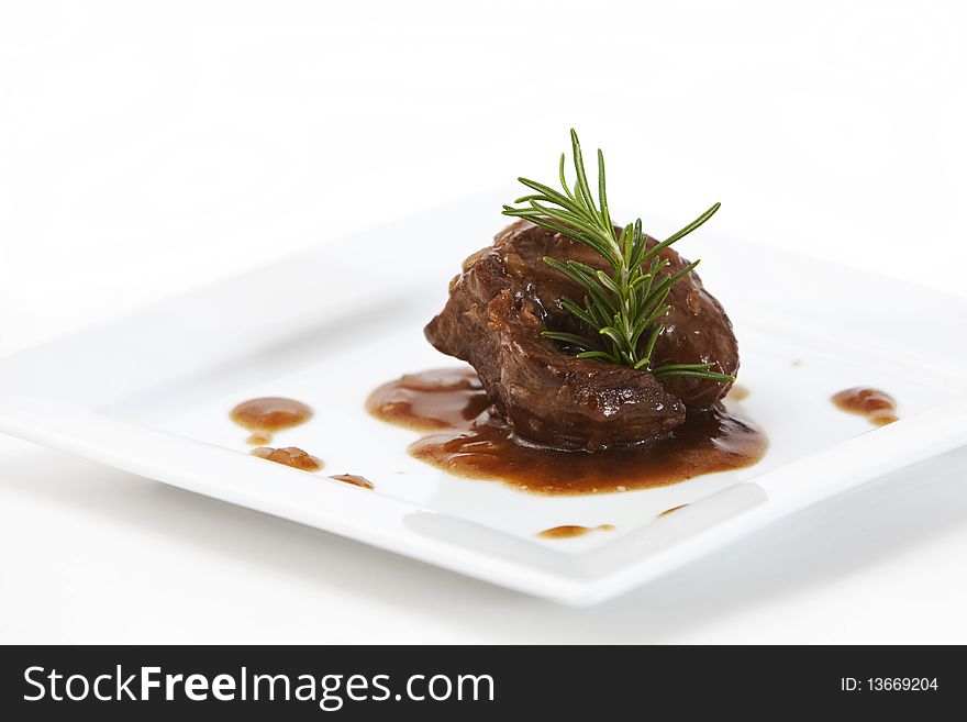 Delicious piece of tenderloin with onion sauce and rosemary