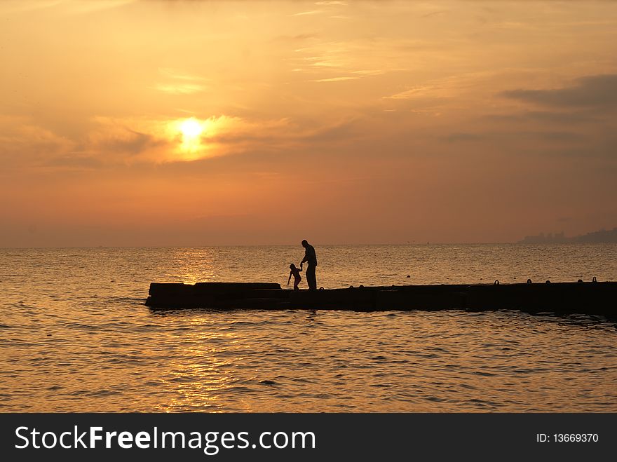 Father and child on the beach. Summer holidays at the Black sea. Father and child on the beach. Summer holidays at the Black sea.