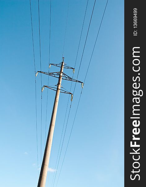 High voltage power supply line on a blue sky background. High voltage power supply line on a blue sky background