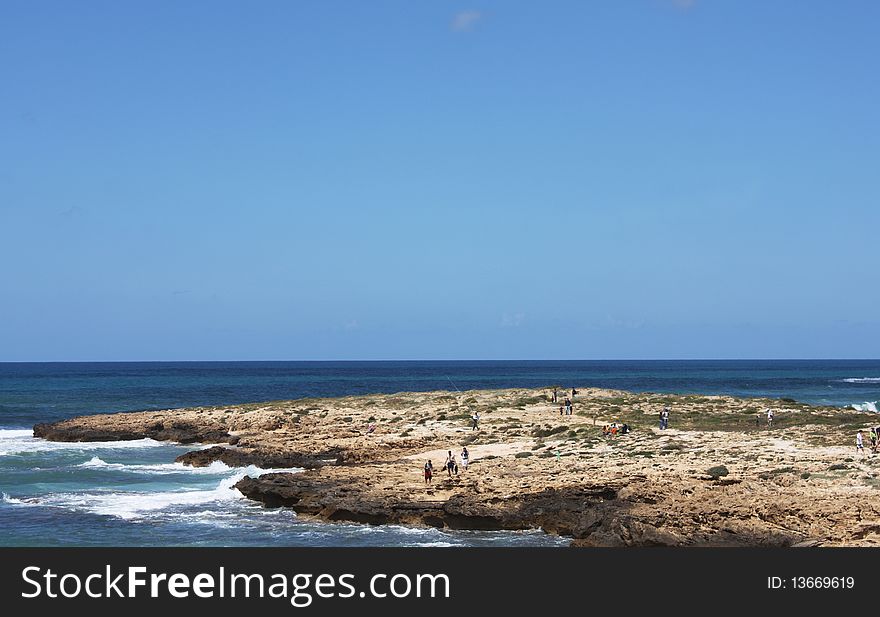 Seascape. Blue sky, sea and a lot of tourists.