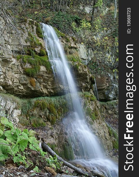 Waterfall near the forest. Photo was taken in early november