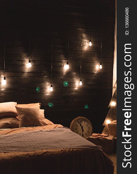 Scandinavian style bedroom interior under Christmas. Textural wooden bed in the style of New Year`s Rustic decorated