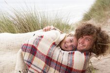 Teenage Couple Sitting In Sand Dunes Wrapped In Bl Stock Photos Teenage Couple Sitting In Sand Dunes Wrapped In Bl Stock Photos