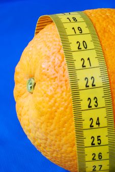 An Orange And A Measuring Tape Stock Photo