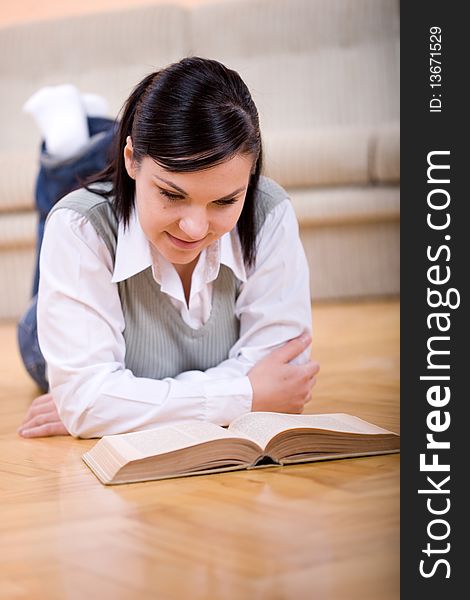 Youing brunette woman reading book at home