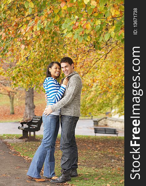 Romantic Teenage Couple Hugging In Autumn Park. Romantic Teenage Couple Hugging In Autumn Park