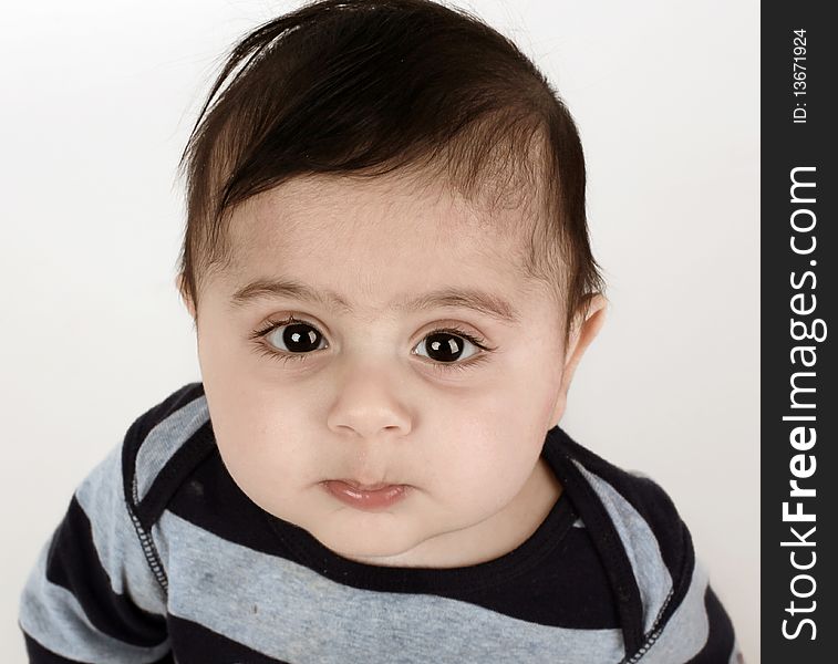 Little baby boy with big dark eyes looking up. Little baby boy with big dark eyes looking up.