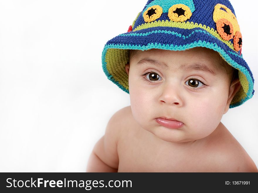 A cute chubby baby wearing a handmade knitted hat. A cute chubby baby wearing a handmade knitted hat.