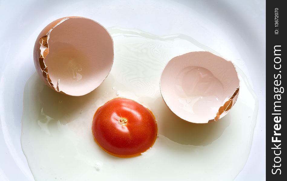 Egg and tomato on a white plate