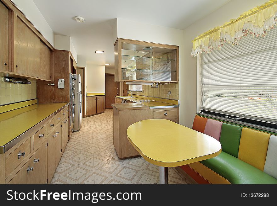 Kitchen with yellow table and multicolored booth. Kitchen with yellow table and multicolored booth