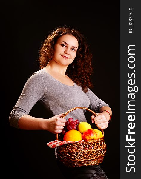 Portrait of young beautiful woman holding fruits in the basket. Portrait of young beautiful woman holding fruits in the basket