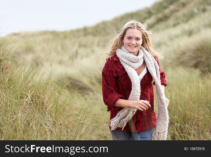 Teenage Girl Walking Through Sand Dunes