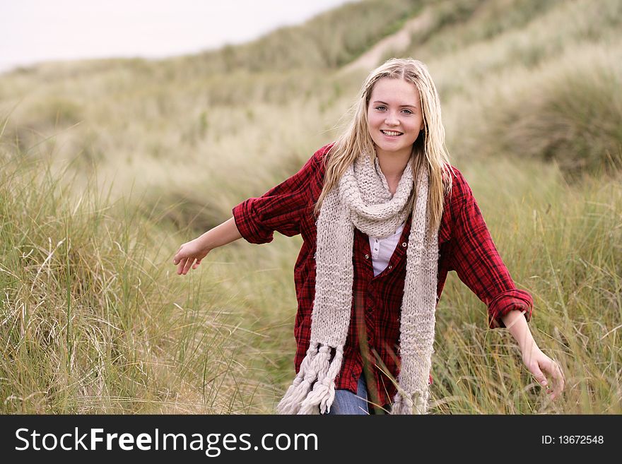 Teenage Girl Walking Through Sand Dunes