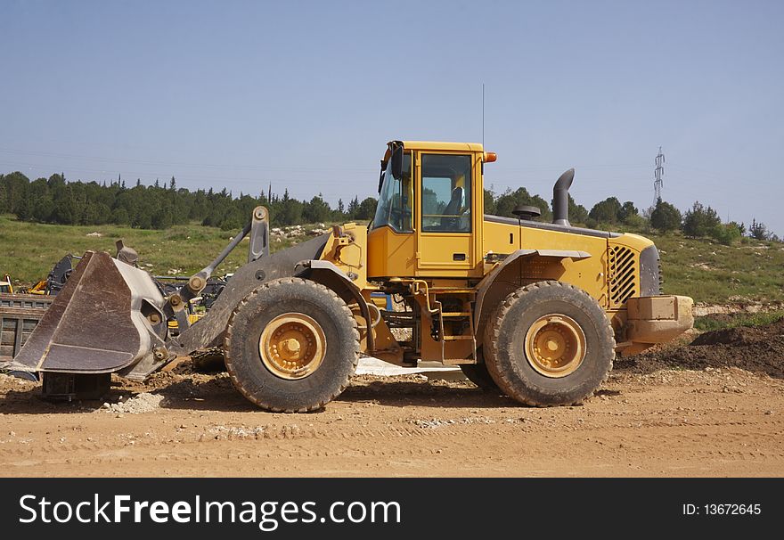 Heavy tractor with trees background