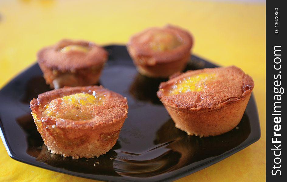 French cake made with some mango caramel, presented on a black plate. French cake made with some mango caramel, presented on a black plate.