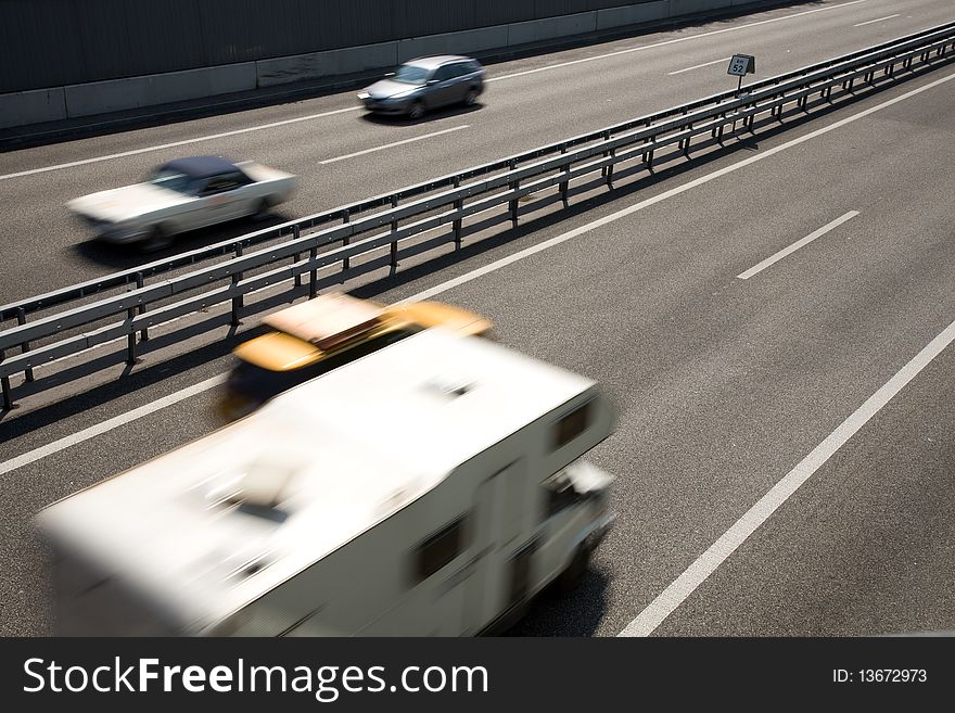 Fast-moving vehicles on the highway.